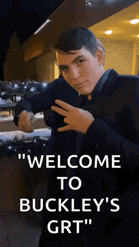 a man in a suit is standing in front of a sign that says welcome to buckley 's grt "