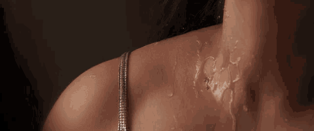 a woman 's neck and shoulder are covered in water