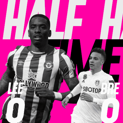 a black and white photo of two soccer players with the words half time written on the bottom