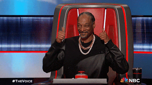 snoop dogg is giving a thumbs up while sitting in a chair on the voice
