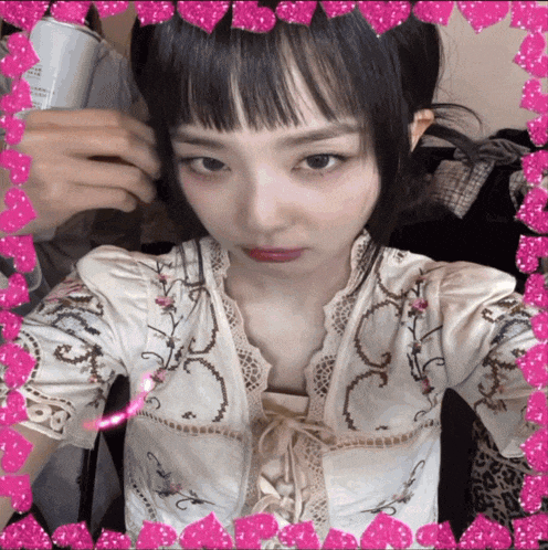 a girl taking a selfie with a pink border around her