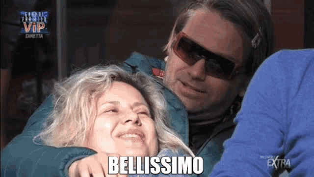 a man is hugging a woman with the word bellissimo written on the bottom