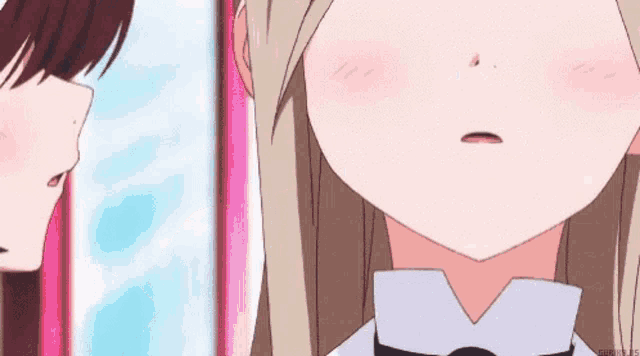 a close up of a girl 's face with a pink nose .