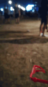 a blurred image of a red object hanging from a wall