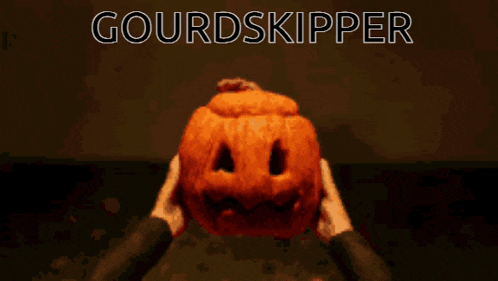 a pumpkin with a face carved into it and the words gourdskipper below it