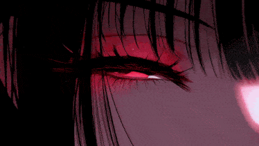 a close up of a girl 's red eye with a black background