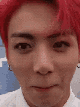 a close up of a person with red hair making a face