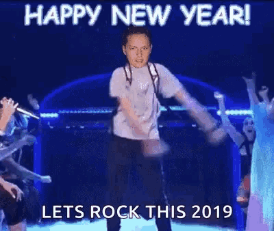 a man is dancing on a stage with the words happy new year let 's rock this 2019 on the bottom .