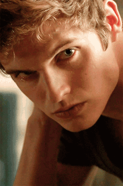 a close up of a young man 's face with a tear running down his cheek