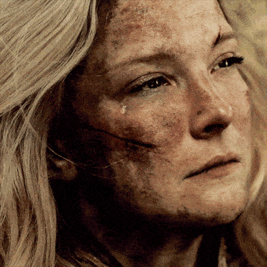a close up of a woman with a tear coming out of her eye