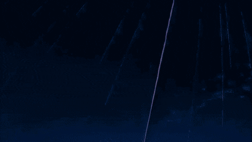 a rocket is flying through a blue sky with shooting stars .