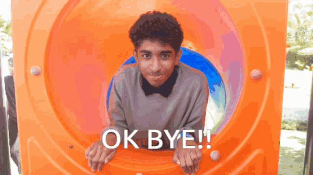 a boy in an orange tunnel with the words ok bye written above him