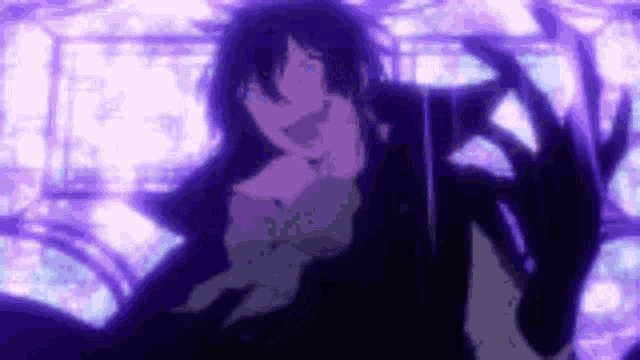 a close up of a person 's face in a dark room with purple lights behind them .