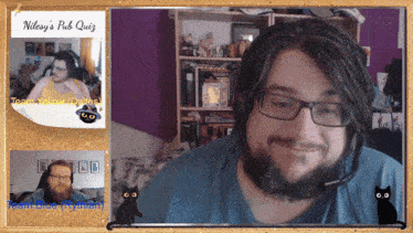 a man with glasses and a beard is smiling in front of a bulletin board that says nilesy 's pub quiz