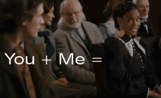 a group of people are sitting in a room with the words `` you + me = '' written in white letters .
