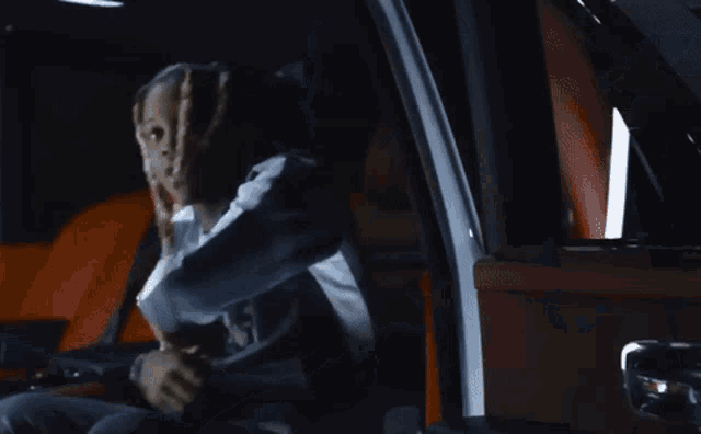 a blurry picture of a person driving a car in the dark