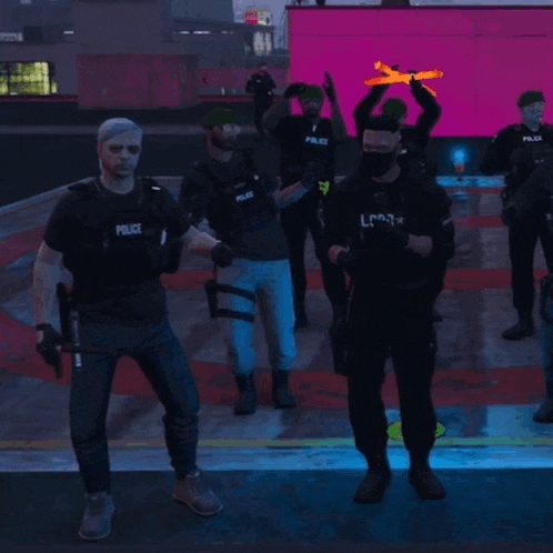 a group of police officers are standing in front of a pink building