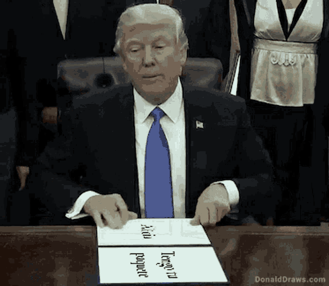 donald trump is sitting at a desk signing a document that says " anti-length property "
