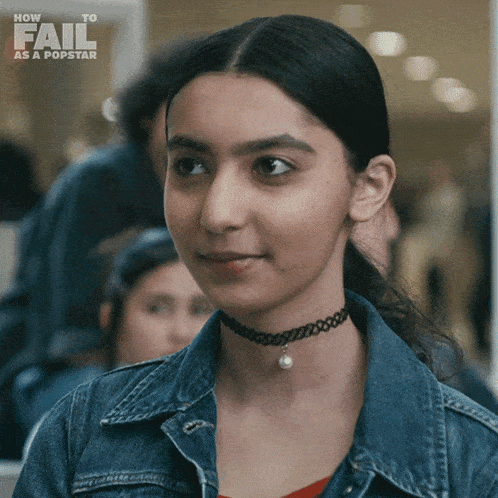 a woman wearing a choker and a denim jacket is featured in a how to fail as a popstar ad