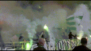 a group of people are holding green flares in front of a banner that says ' nl '