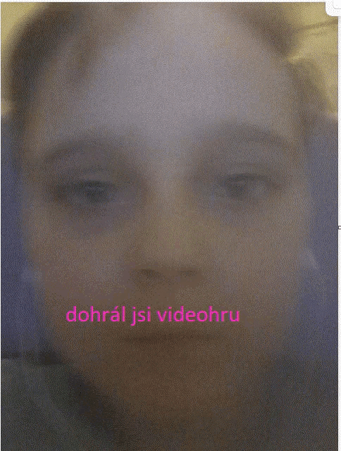 a blurred image of a person 's face with the words dohral jsi videohru written in pink