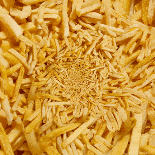 a bunch of french fries are scattered in a circular pattern