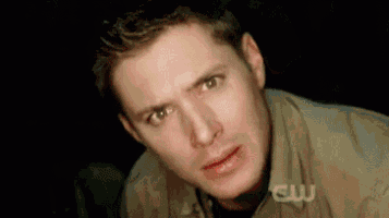 a close up of a man 's face in a dark room .