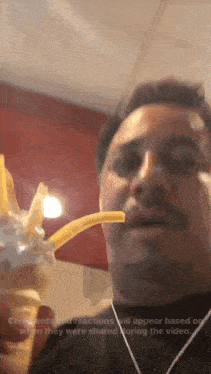 a man is eating french fries with a straw and comments and reactions will appear based on when they were shared