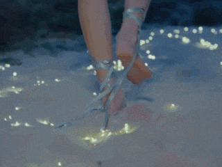 a close up of a woman 's feet with ribbons around the ankles