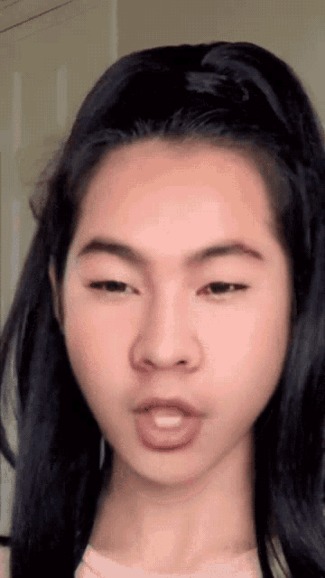 a close up of a girl 's face with a ponytail