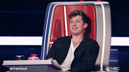 a man sits in a chair with a nbc logo on the bottom right