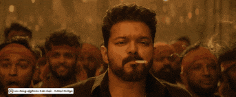 a man smoking a cigarette in front of a crowd with a sticker that says ' i am talking ' on it