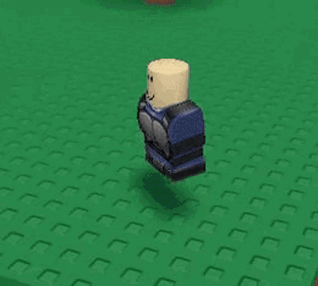 a roblox character with a smiley face on his head is standing in the grass .