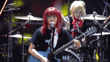 a woman singing into a microphone with a ma drum