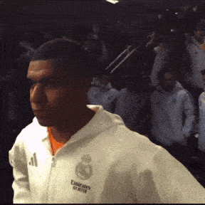 a man wearing a white jacket with emirates fly better on it