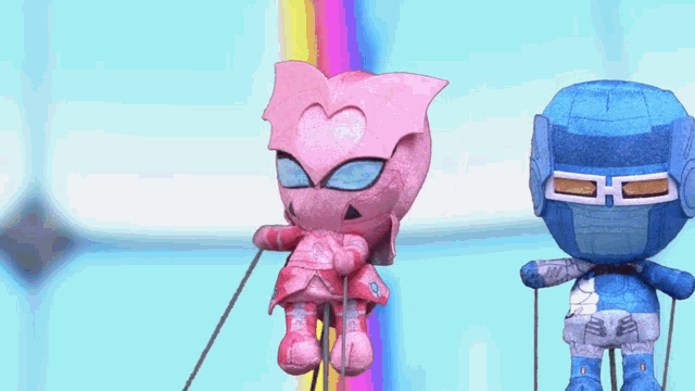 a pink alien and a blue ninja are hanging on a rope