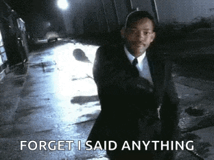 a man in a suit and tie is walking down a street and says forget i said anything .