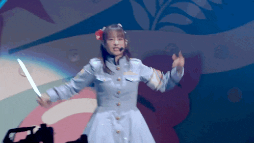 a girl in a blue dress is holding a knife