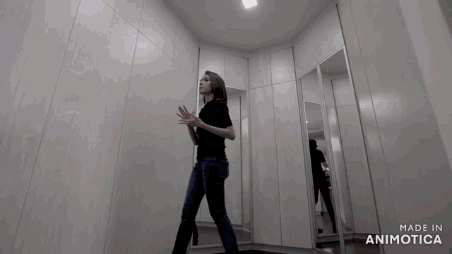 a woman standing in a room with the words made in animotica on the bottom right