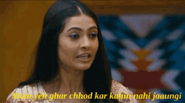 a close up of a woman 's face with the words main yeh ghar chhod kar nahin nahi jaaungi above her