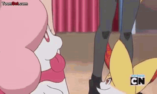a couple of cartoon characters are standing next to each other on a stage .