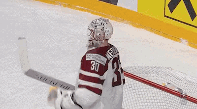 a hockey game between italy and latvia with the score 1 to 2