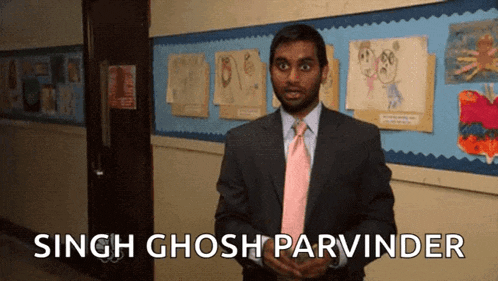 a man in a suit and tie says singh ghosh parvinder in front of a bulletin board