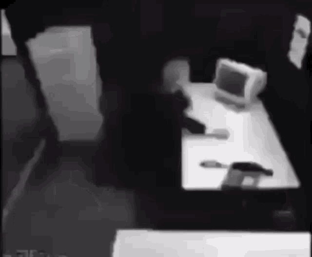 a person sitting at a desk with a computer on it