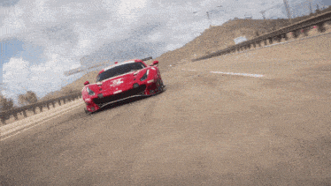 a red sports car is driving down a road
