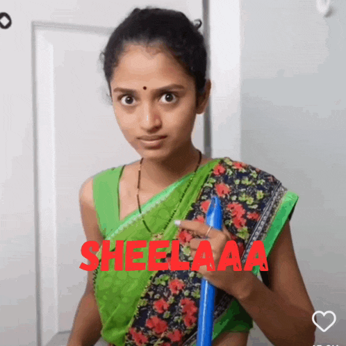 a woman in a green sari is holding a blue broom and the word sheelaaa is on the bottom right