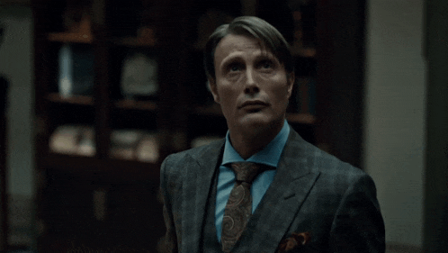 a man in a suit and tie says yes in yellow