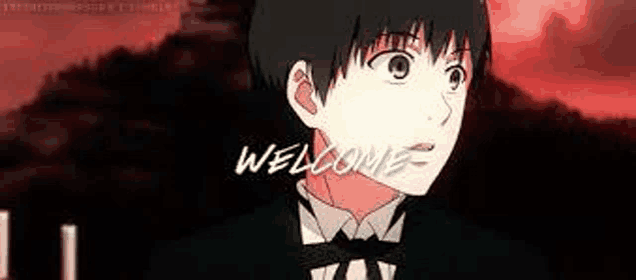 a man in a tuxedo and bow tie is standing in front of a sign that says `` welcome '' .