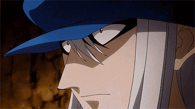 a close up of a person 's face with a blue hat