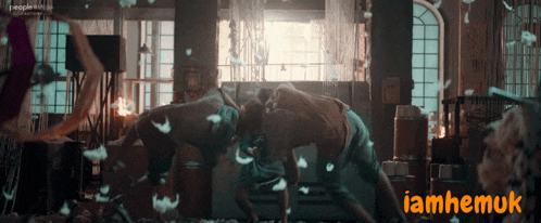 a man and a woman are dancing in a room with the words iamhemuk on the bottom right
